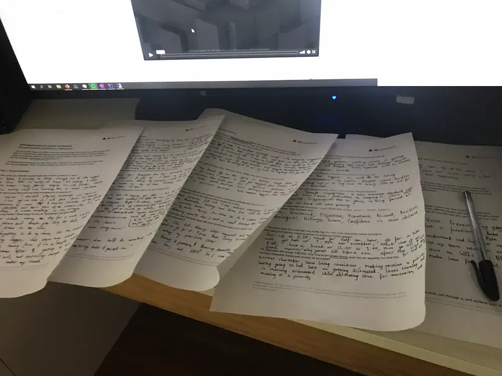 Handwritten action-item worksheets on a desk